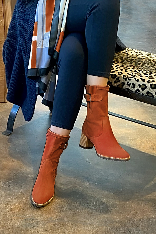 Terracotta orange women's ankle boots with buckles on the sides. Round toe. Medium block heels. Worn view - Florence KOOIJMAN